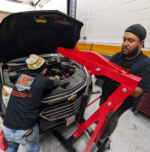 Mechanics working on car